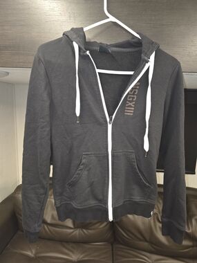 Black full-zip hoodie, a signature piece from No Surrender Gear